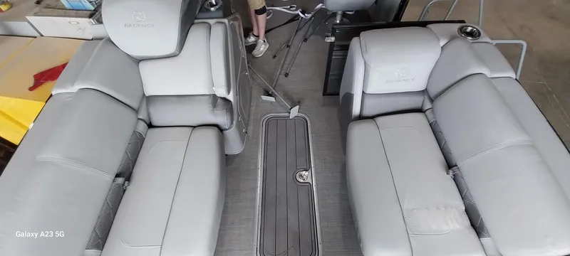 Slide: The Image of 2023 Regency 250 LE3 Sport boat interior with gray seating and flooring. - 5