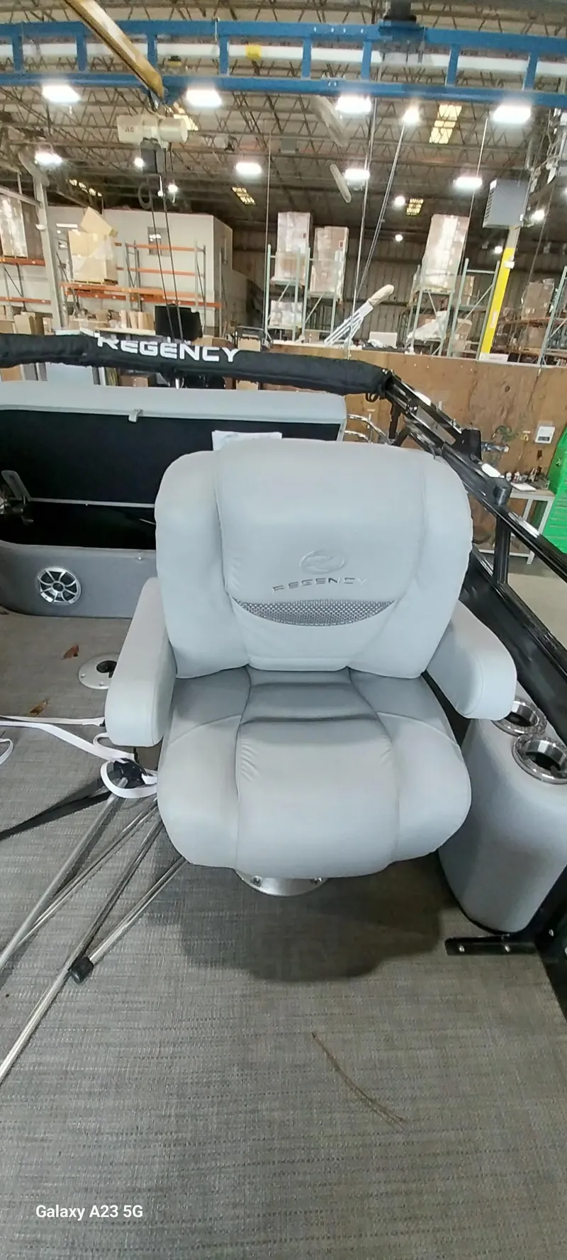 Slide: The Image of 2023 Regency 250 LE3 Sport boat seat in a factory setting. - 6