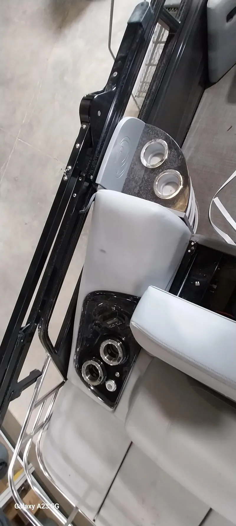 Slide: The Image of 2023 Regency 250 LE3 Sport boat interior with cup holders and control panel. - 7