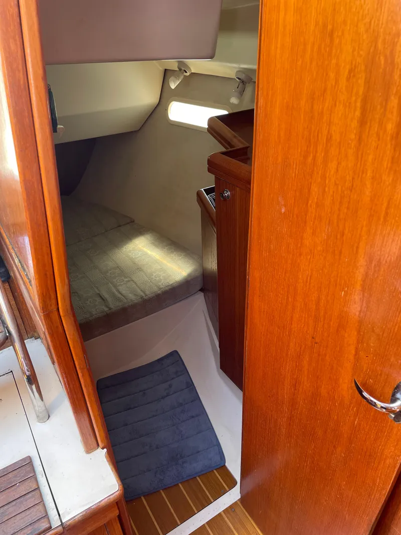 Slide: The Image of Interior cabin of a 2001 Hunter 306 sailboat with wooden finishes. - 14