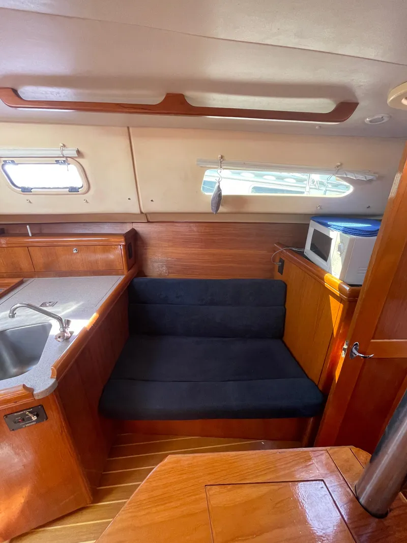 Slide: The Image of Interior of 2001 Hunter 306 sailboat with seating, sink, and microwave. - 15