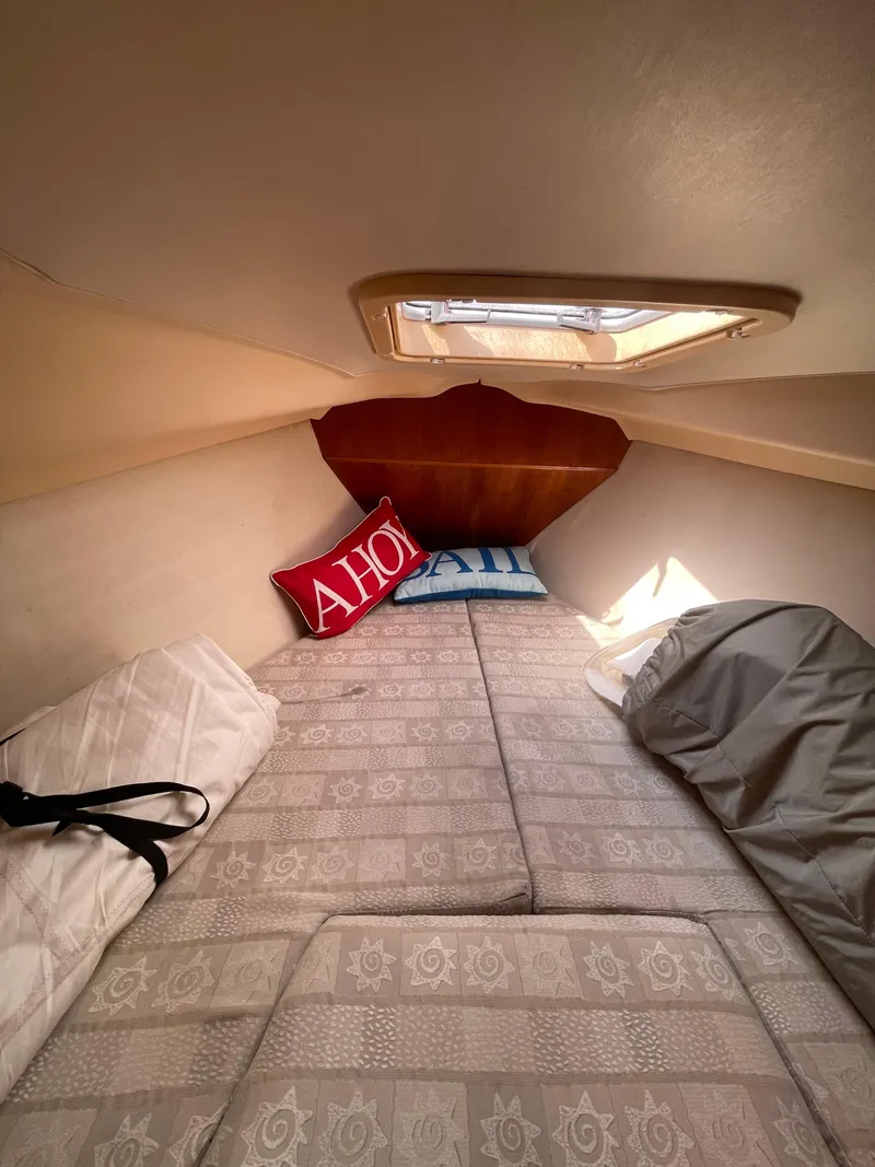 Slide: The Image of Cozy cabin interior of 2001 Hunter 306 sailboat with decorative pillows and bedding. - 8