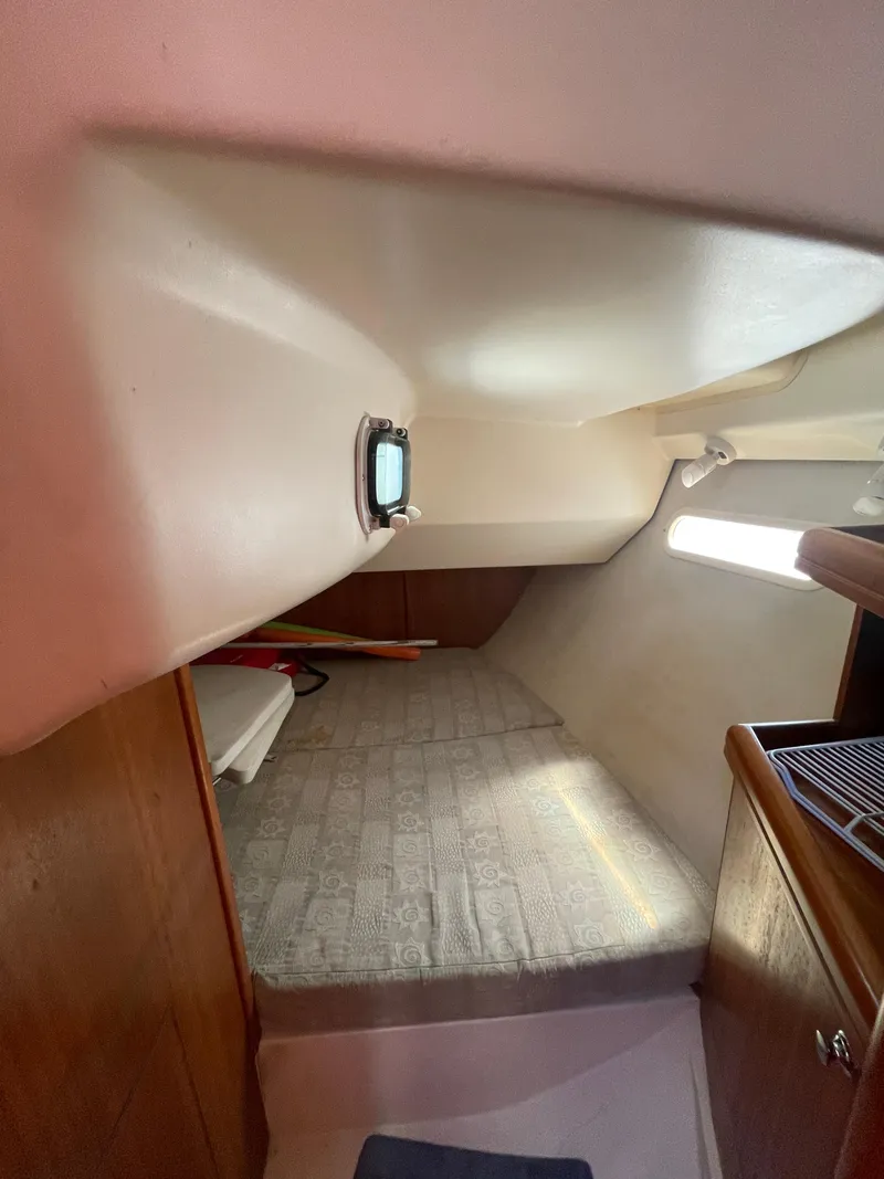 Slide: The Image of Interior cabin of a 2001 Hunter 306 sailboat with a cozy sleeping area. - 9