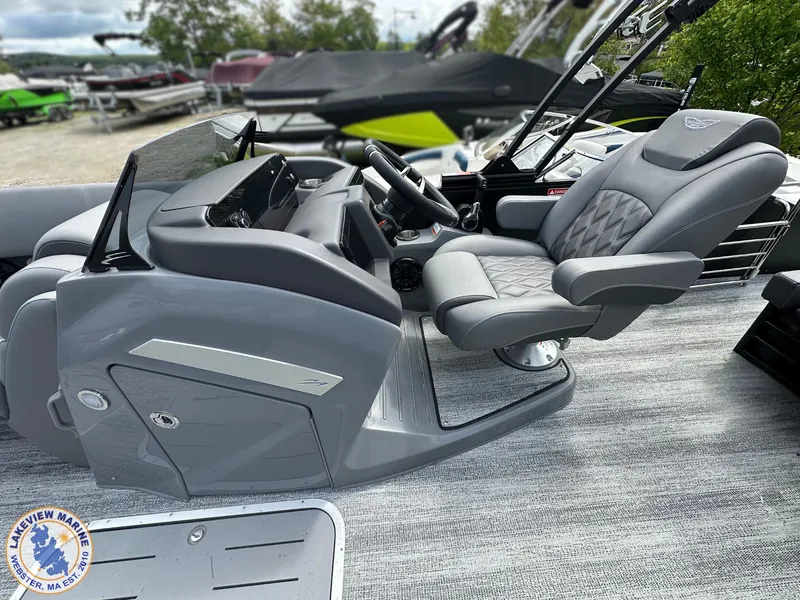 Slide: The Image of 2025 Bennington 23 LXSSB boat interior with sleek gray captain's chair and dashboard. - 5