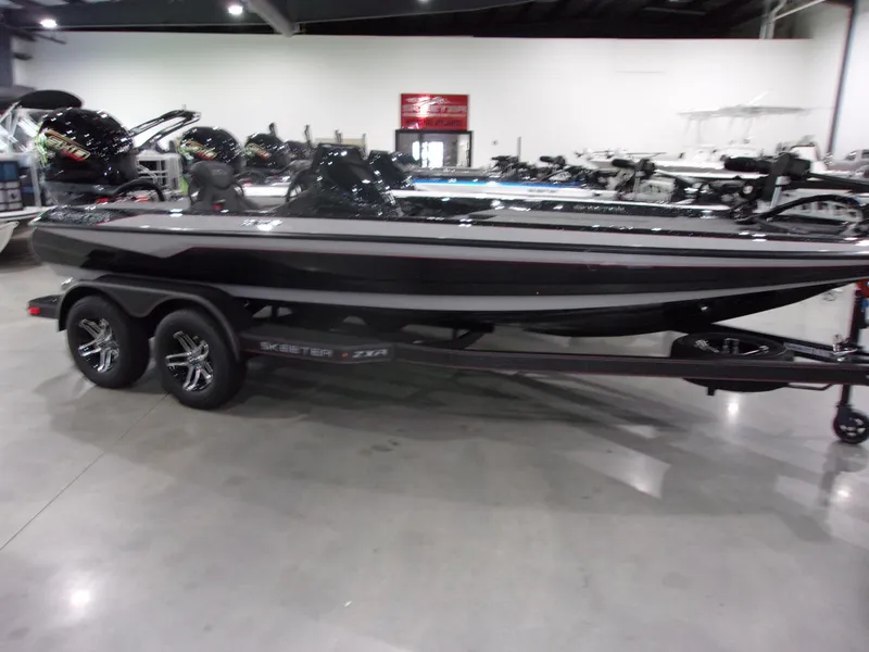 Slide: The Image of 2026 Skeeter ZXR-19 boat on display in a showroom, featuring sleek design and dual-axle trailer. - 3