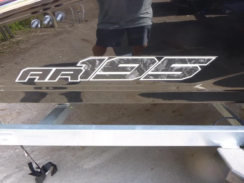 Slide: The Image of 2025 Yamaha Boats AR195 logo on a boat hull, reflecting surroundings. - 12