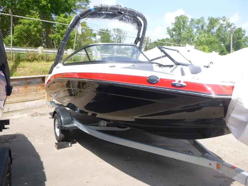 Slide: The Image of 2025 Yamaha Boats AR195 on trailer, black and red design, parked outdoors. - 2