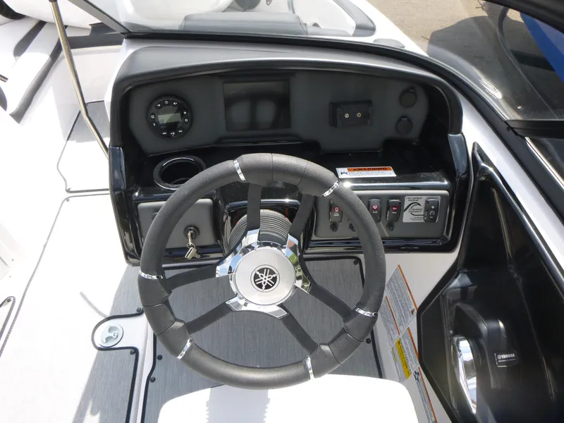 Slide: The Image of 2025 Yamaha AR195 boat dashboard with steering wheel and control panel. - 7
