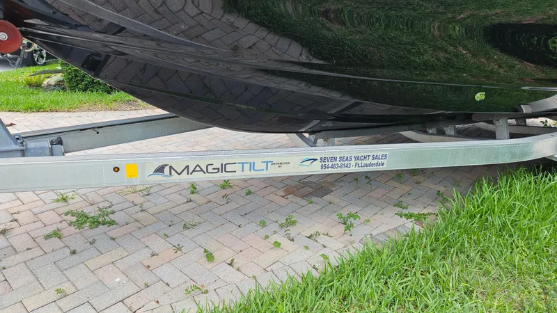 Slide: The Image of Trailer for 2021 Scout 231 XS boat by Magic Tilt, on brick pavement. - 11
