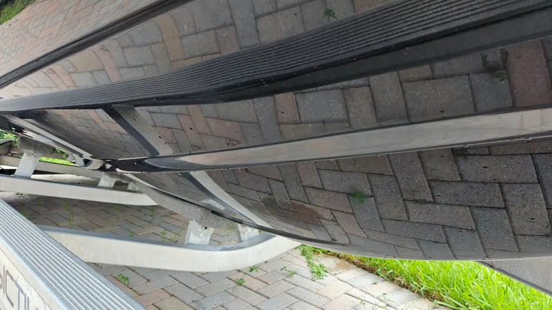 Slide: The Image of Bottom view of a 2021 Scout 231 XS boat on a trailer. - 13