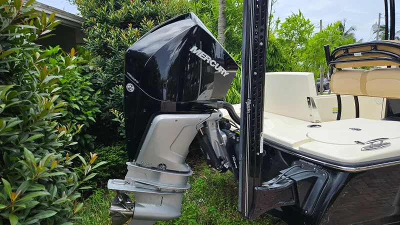 Slide: The Image of 2021 Scout 231 XS boat with Mercury outboard motor, surrounded by lush greenery. - 15
