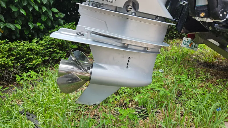 Slide: The Image of Outboard motor of 2021 Scout 231 XS boat, featuring a shiny propeller. - 18