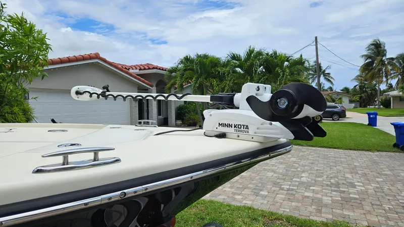 Slide: The Image of 2021 Scout 231 XS boat with Minn Kota Terrova motor in residential driveway. - 24