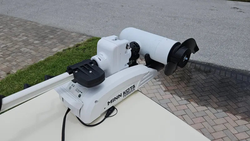 Slide: The Image of Minn Kota Terrova trolling motor on 2021 Scout 231 XS boat, parked on brick driveway. - 25