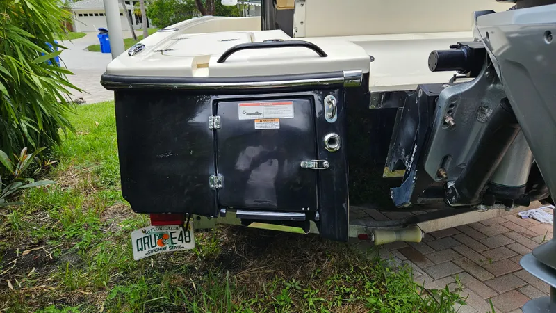 Slide: The Image of 2021 Scout 231 XS boat rear view with Florida license plate on grass. - 26