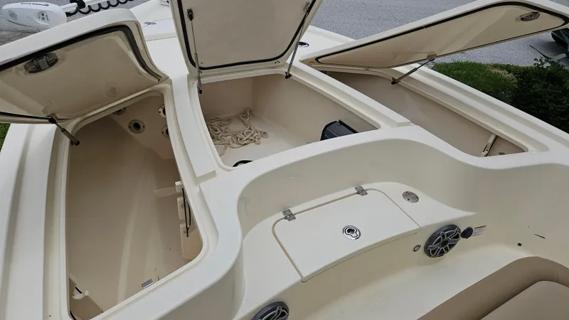Slide: The Image of 2021 Scout 231 XS boat interior with open storage compartments and speakers. - 28