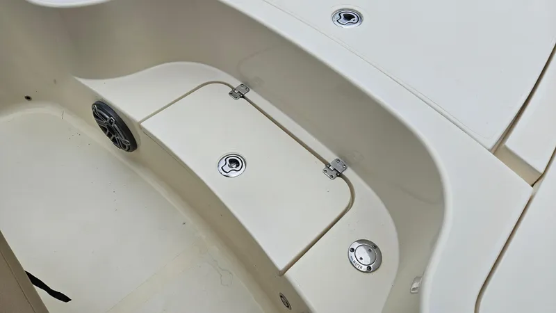 Slide: The Image of 2021 Scout 231 XS boat interior with storage compartment and speaker. - 30