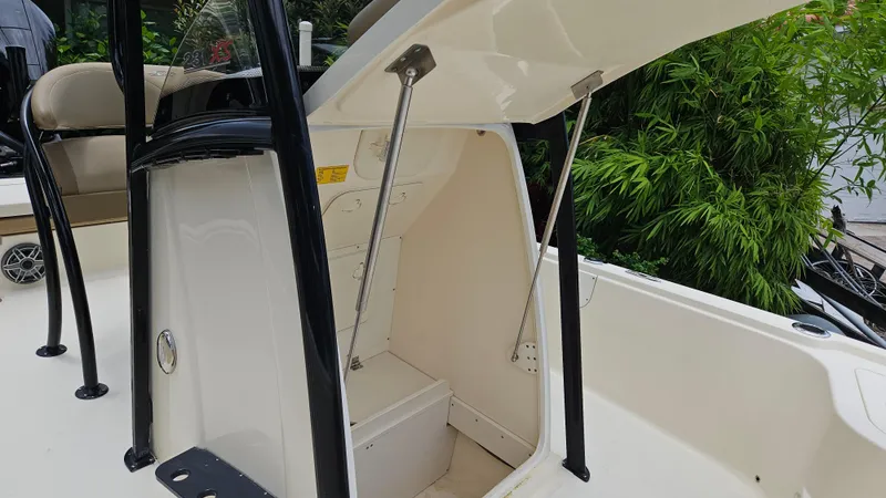 Slide: The Image of 2021 Scout 231 XS boat storage compartment open, showcasing interior space and design. - 33