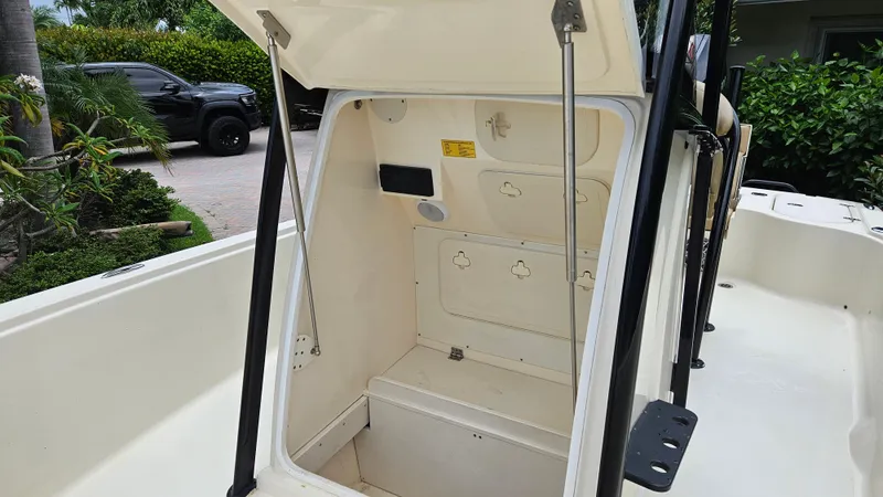 Slide: The Image of 2021 Scout 231 XS boat interior storage compartment with open hatch, showcasing spacious design. - 34