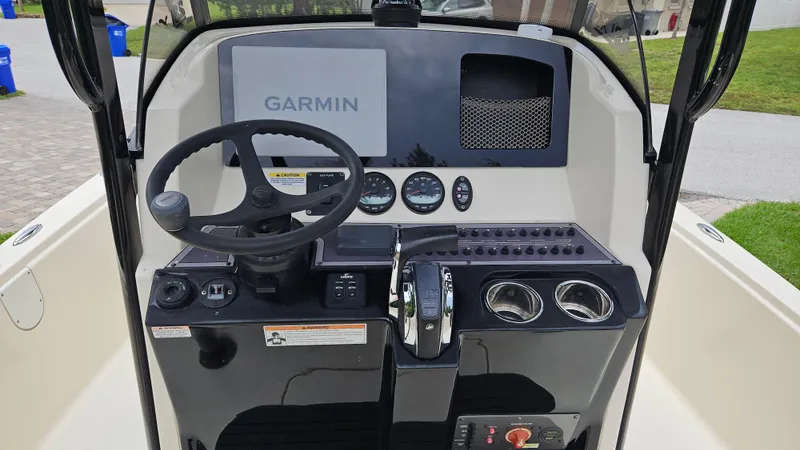 Slide: The Image of 2021 Scout 231 XS boat console with Garmin display and steering wheel. - 39