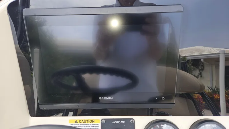 Slide: The Image of Garmin display on 2021 Scout 231 XS boat dashboard with caution label visible. - 44