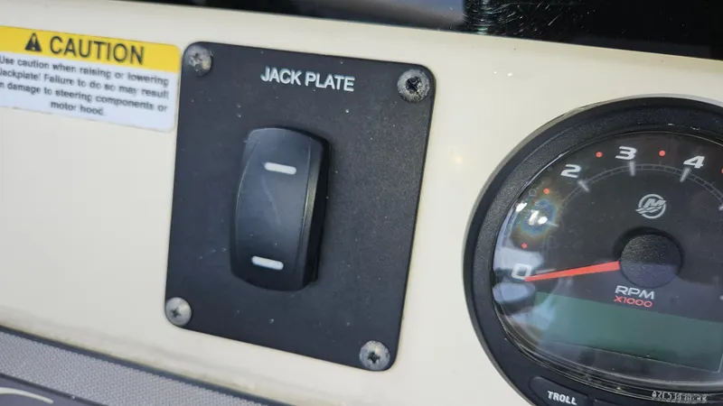 Slide: The Image of 2021 Scout 231 XS boat dashboard with jack plate switch and RPM gauge. - 49