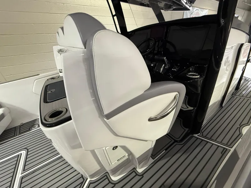 Slide: The Image of 2024 Sunsation 34 CCX boat interior with sleek seating and modern dashboard design. - 11