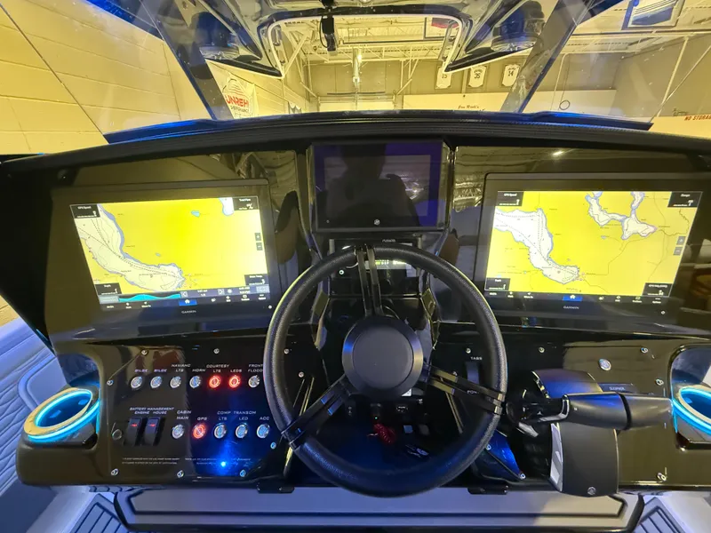 Slide: The Image of 2024 Sunsation 34 CCX dashboard with dual navigation screens and steering wheel. - 14