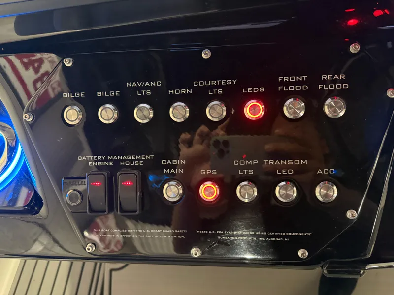 Slide: The Image of Control panel of 2024 Sunsation 34 CCX boat with various switches and indicators. - 16
