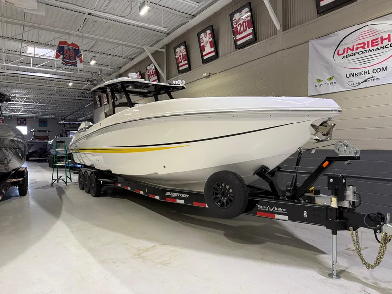 Slide: The Image of 2024 Sunsation 34 CCX boat on trailer in showroom with sports memorabilia. - 2