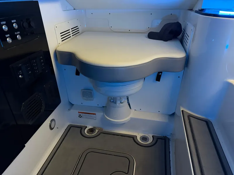 Slide: The Image of 2024 Sunsation 34 CCX boat interior with cushioned seating and control panel. - 20