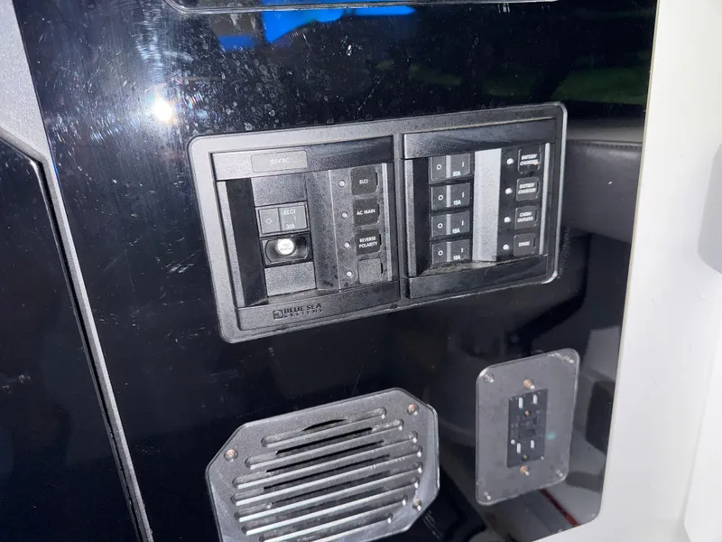 Slide: The Image of 2024 Sunsation 34 CCX control panel with switches and outlets. - 21