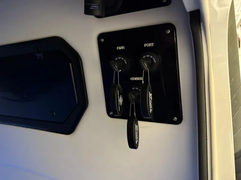 Slide: The Image of 2024 Sunsation 34 CCX boat ignition panel with keys and switches. - 22