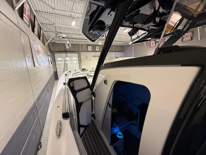 Slide: The Image of 2024 Sunsation 34 CCX boat interior with open cabin door in a showroom. - 23