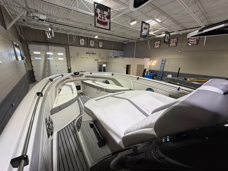 Slide: The Image of 2024 Sunsation 34 CCX boat interior in a showroom with sports memorabilia. - 24