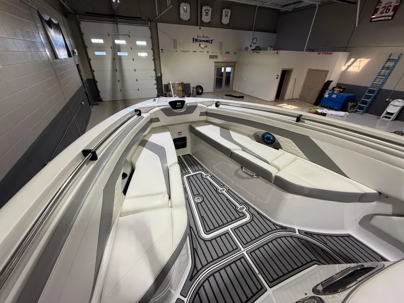 Slide: The Image of 2024 Sunsation 34 CCX boat interior with sleek seating and modern design in a showroom. - 25