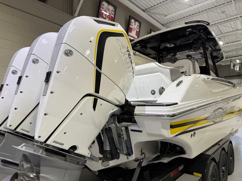 Slide: The Image of 2024 Sunsation 34 CCX boat with triple outboard engines in a showroom. - 3