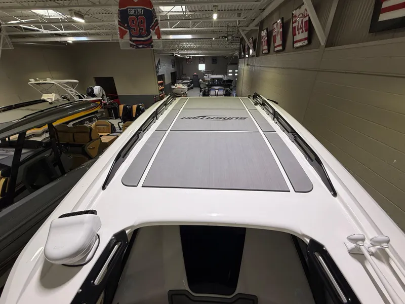 Slide: The Image of 2024 Sunsation 34 CCX boat interior in showroom, featuring sleek design and modern finishes. - 30