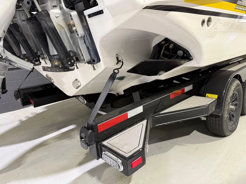 Slide: The Image of 2024 Sunsation 34 CCX boat on trailer, rear view with visible engine mounts. - 5