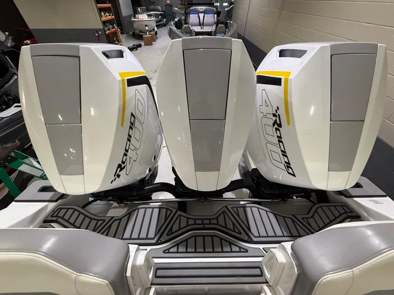 Slide: The Image of 2024 Sunsation 34 CCX with triple Racing 400 outboard engines in a showroom. - 7