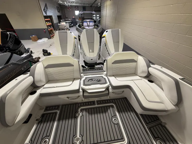Slide: The Image of 2024 Sunsation 34 CCX boat interior with luxurious seating and modern design in a showroom. - 8