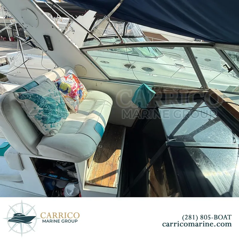 Slide: The Image of 1990 Sea Ray 390 Express Cruiser interior with cushions, docked at Carrico Marine Group. - 13