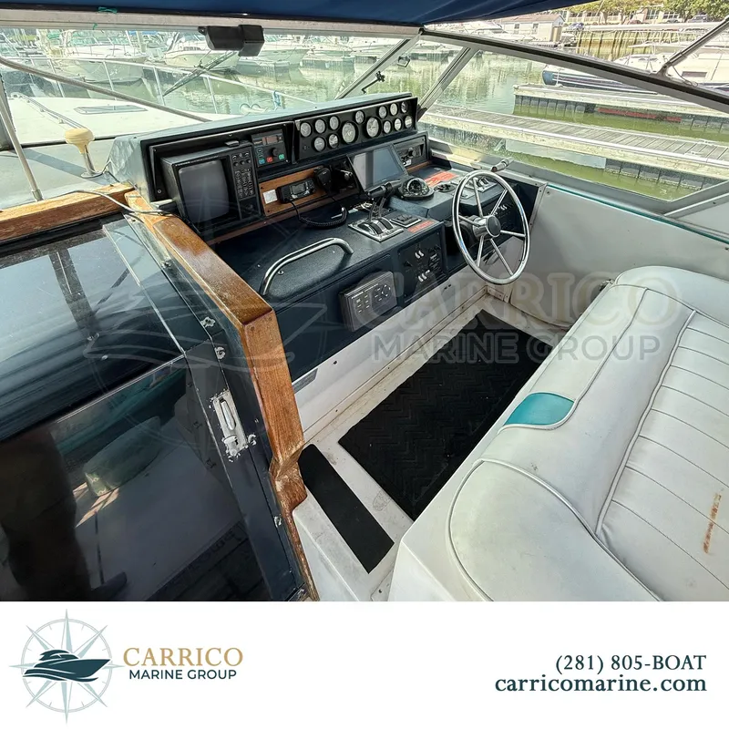 Slide: The Image of 1990 Sea Ray 390 Express Cruiser helm with steering wheel and control panel. - 14