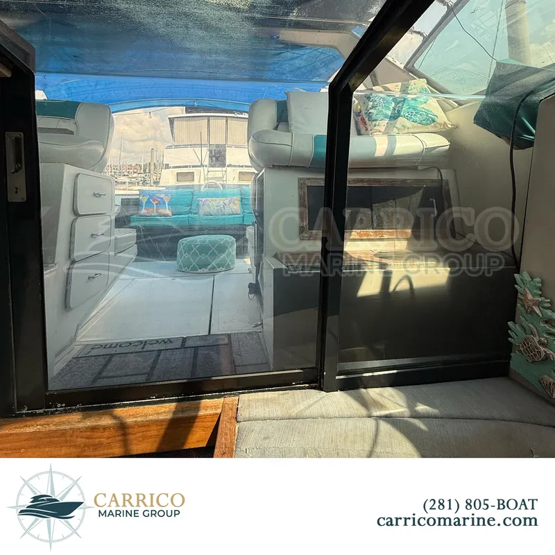 Slide: The Image of Interior view of 1990 Sea Ray 390 Express Cruiser with seating and decor. - 16