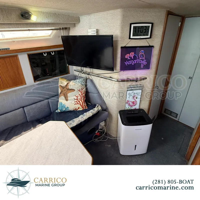 Slide: The Image of Interior of 1990 Sea Ray 390 Express Cruiser with cozy seating and modern amenities. - 19