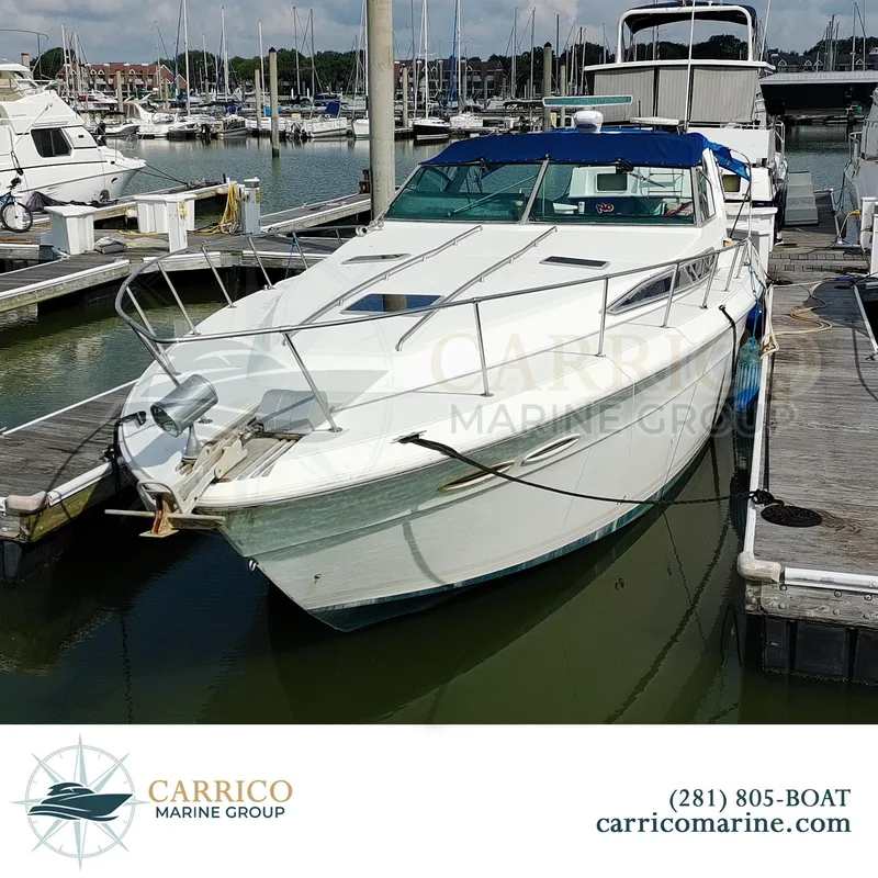 Slide: The Image of 1990 Sea Ray 390 Express Cruiser docked at marina, Carrico Marine Group. - 2