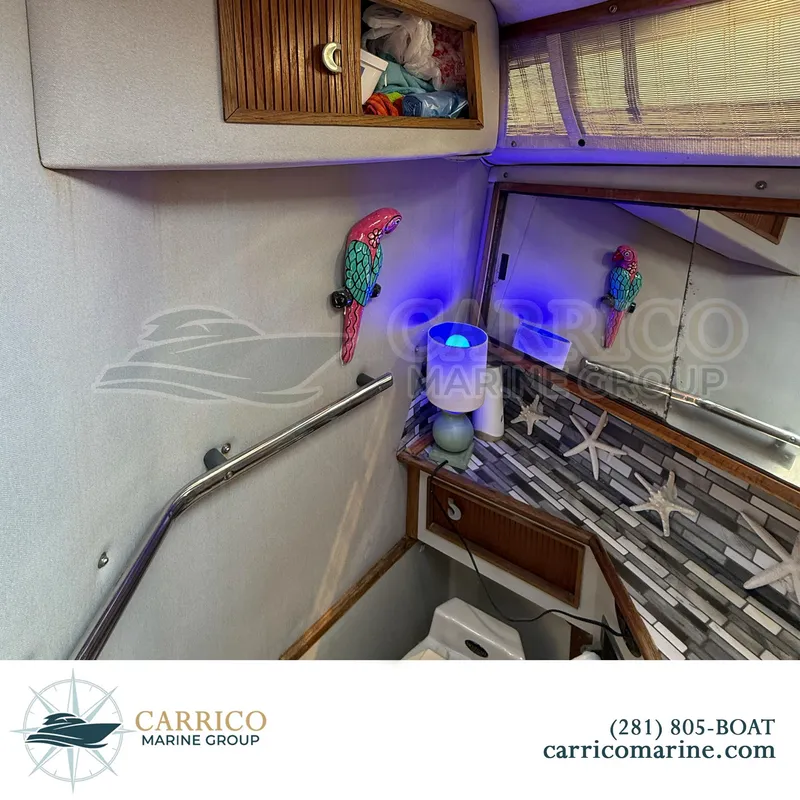 Slide: The Image of 1990 Sea Ray 390 Express Cruiser interior with nautical decor and vibrant lighting. - 27