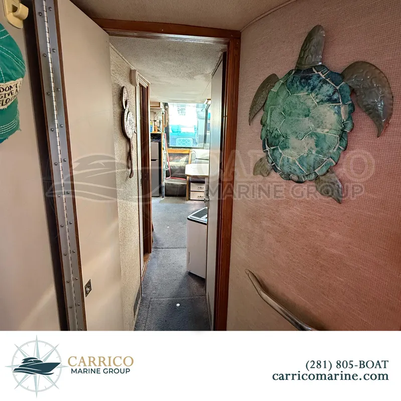 Slide: The Image of Interior view of 1990 Sea Ray 390 Express Cruiser with turtle wall decor. - 29