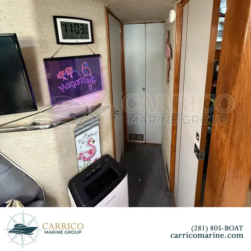 Slide: The Image of Interior of 1990 Sea Ray 390 Express Cruiser with Margaritaville decor and digital clock. - 30