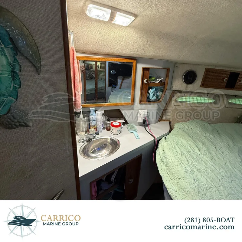 Slide: The Image of 1990 Sea Ray 390 Express Cruiser cabin interior with sink, mirror, and bed. - 31